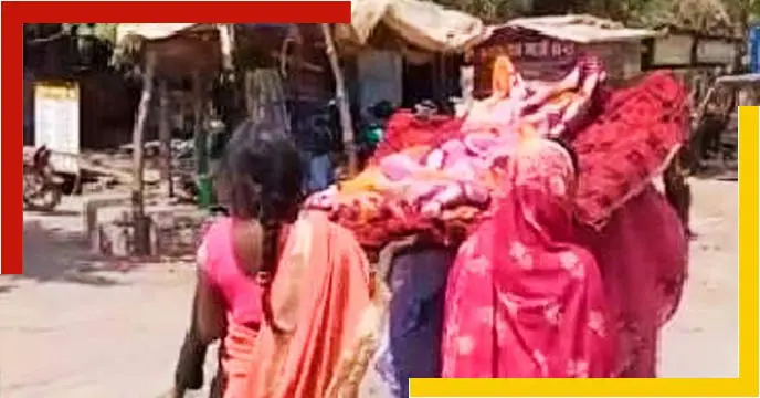 Women Carry Relative’s Body