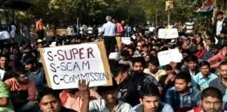 Protests Surround DI Offices: The Commission's Corpse on Their Shoulders, Children on Their Laps Holding Placards