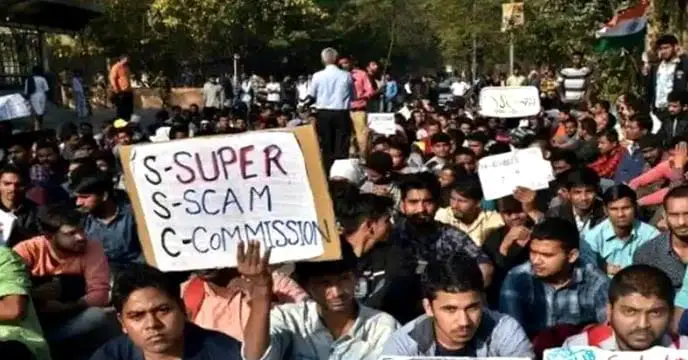 Protests Surround DI Offices: The Commission's Corpse on Their Shoulders, Children on Their Laps Holding Placards