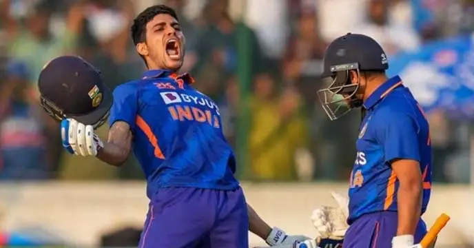 Shubman Gill playing cricket with a bat and helmet on a green field