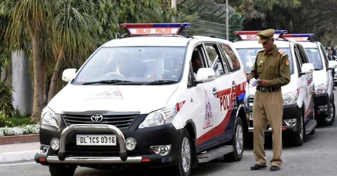 A group of people holding placards and raising slogans during a protest. One of the placards reads "Save Democracy, Save Constitution"