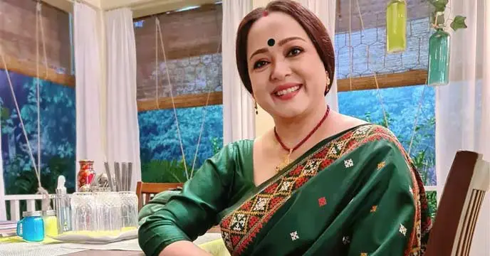 Aparajita Adhya wearing red saree with a flower garland around her neck