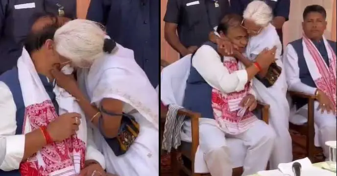 Elderly woman kissing Assam CM Himanta Biswa Sarma on stage.