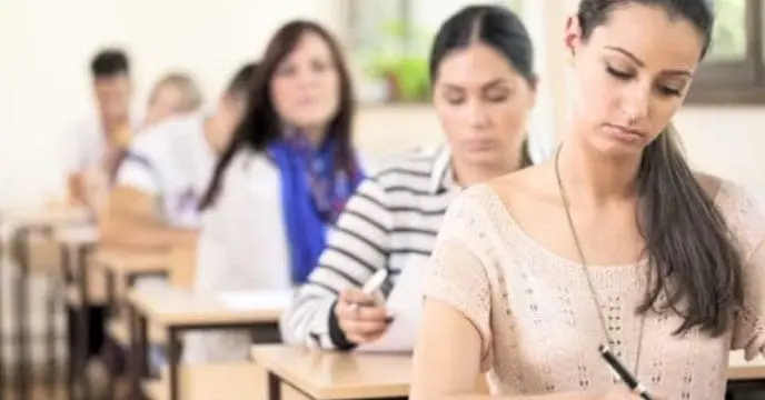 A girl holding a newspaper with the headline 'job news'