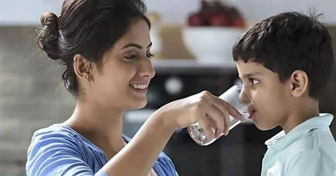 Young Indian woman pouring water through an RO filter