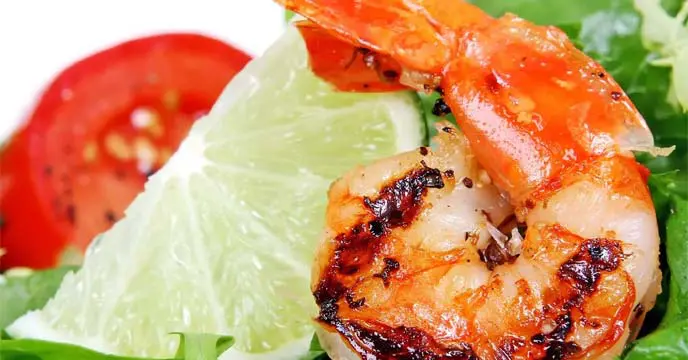 Plate of seafood including salmon, shrimp, and mussels