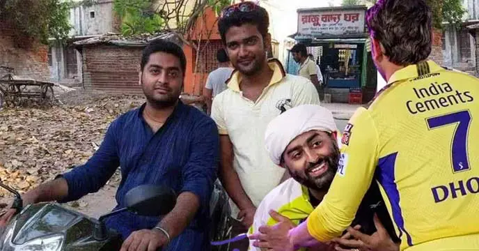 Arijit Singh, the popular Indian singer, smiling for the camera.