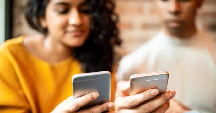 Illustration of a girl using a mobile phone while being cautious of online fraud.