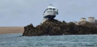 Boat gets stuck 10 feet on top of a rock