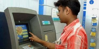 Person withdrawing cash from ATM