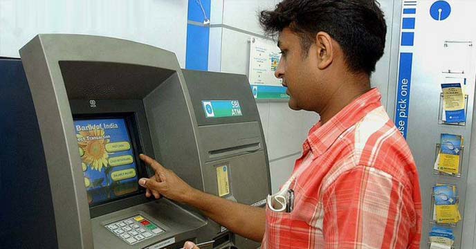 Person withdrawing cash from ATM