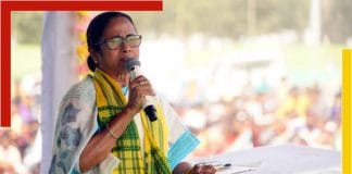 Image of Mamata Banerjee, the Chief Minister of West Bengal, standing in front of a microphone