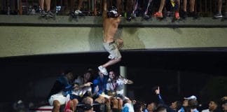 Argentine fans leap from bridge