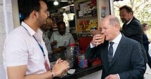 german chancellor Olaf Scholz takes tea at a street corner in delhi