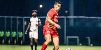 Cleiton Silva, a Brazilian football player, posing in a blue and red jersey