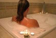 Girl using hot water to relieve back pain
