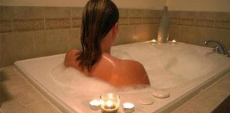 Girl using hot water to relieve back pain