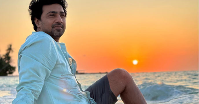 Bengali actor Dev posing with a wide smile in the Maldives
