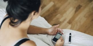 Indian woman checking her blood sugar levels due to diabetes issues