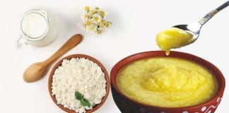 Bowl of hot rice with a spoonful of ghee on top.