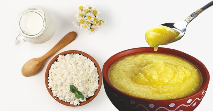 Bowl of hot rice with a spoonful of ghee on top.