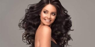 Woman applying henna on her hair for healthy hair growth