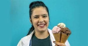 Young Indian girl enjoying a scoop of ice cream in a cone.