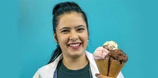 Young Indian girl enjoying a scoop of ice cream in a cone.
