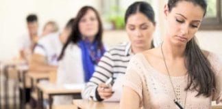 A girl holding a newspaper with the headline 'job news'