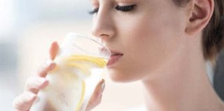 A girl drinking lemon water in summer