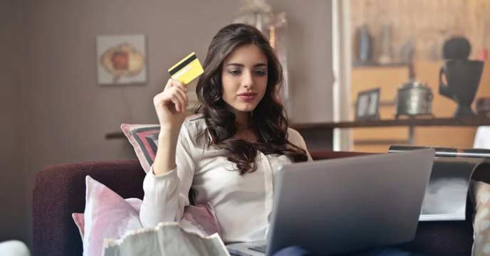 Woman shopping online with laptop and credit card