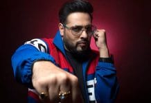 Rapper Badshah posing for a photograph in a black and white outfit