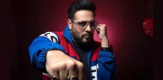 Rapper Badshah posing for a photograph in a black and white outfit