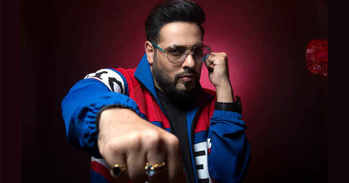 Rapper Badshah posing for a photograph in a black and white outfit