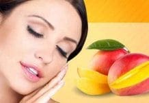 Woman holding a ripe mango, showcasing the skin benefits of mango in summer.