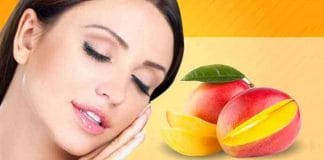 Woman holding a ripe mango, showcasing the skin benefits of mango in summer.