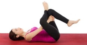 Woman maintaining a straight spine by balancing weight on her shoulders.