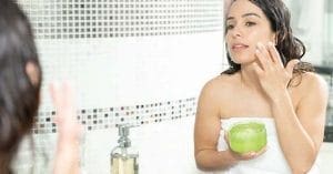 Woman applying Aloe Vera gel on sunburnt skin