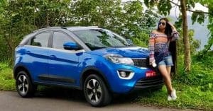 Girl posing with a Tata Nexon car