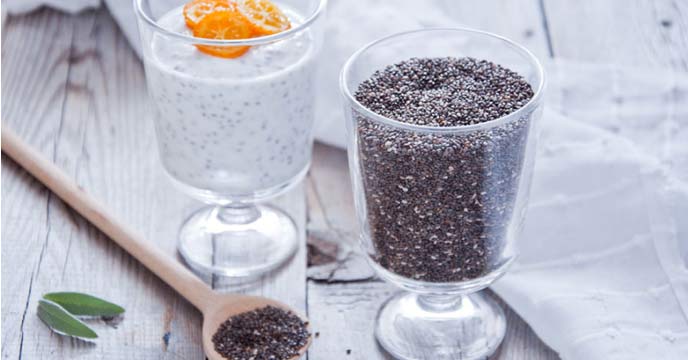 A bowl of chia seeds with a spoon and measuring tape