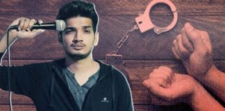 Comedian Munawar Faruqui standing in front of a microphone on stage