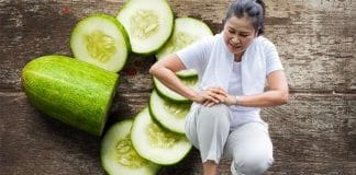A bowl of fresh cucumbers on a wooden table