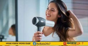 Woman using hair dryer