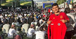Saul Crespo Embraces Euro Spirit in Berlin with Red-and-Yellow T-Shirt in Hand"