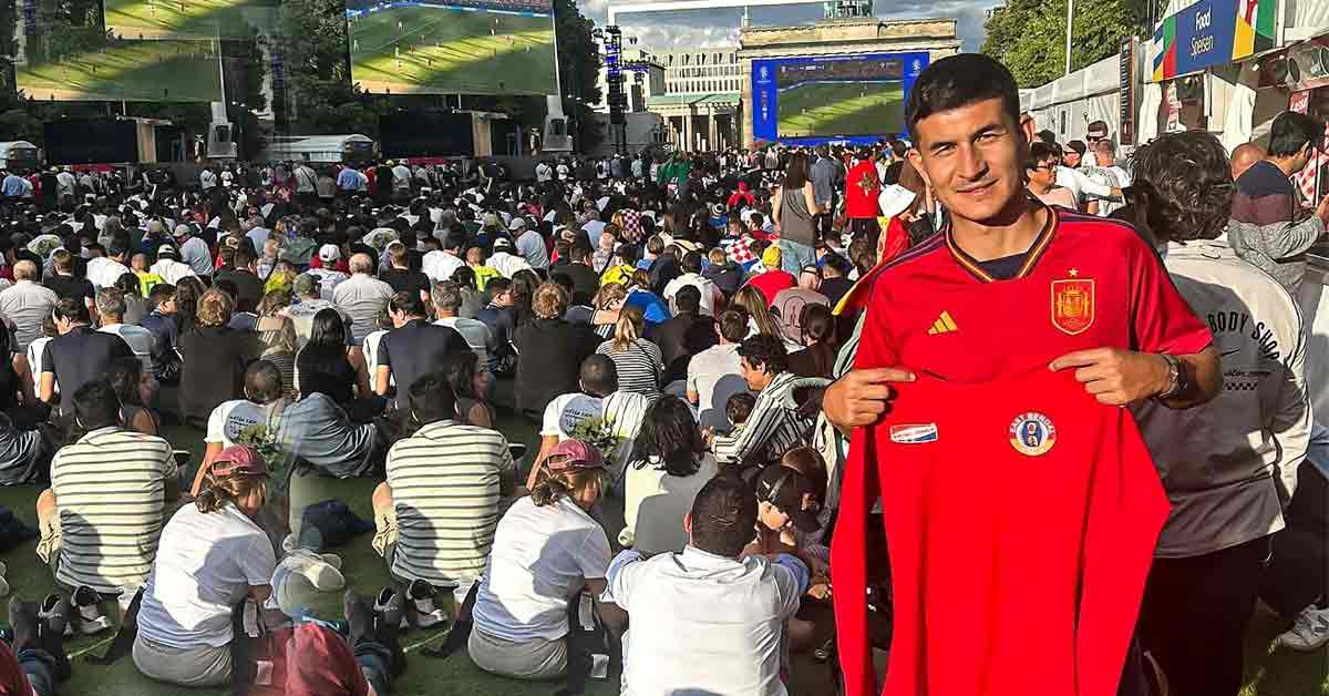 Saul Crespo Embraces Euro Spirit in Berlin with Red-and-Yellow T-Shirt in Hand"