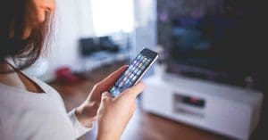 Woman Wearing White V Neck Shirt Using Spac Iphone
