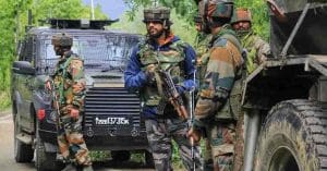 Soldier in Jammu and Kashmir standing guard in mountainous terrain