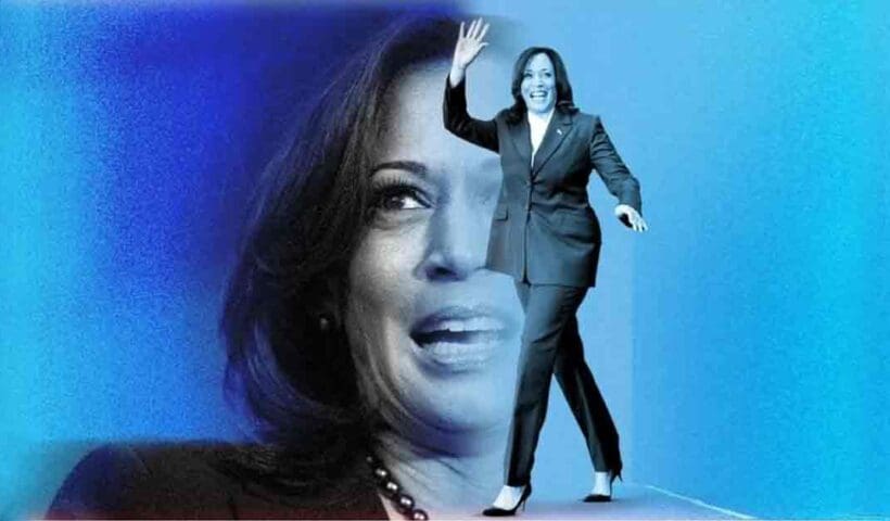 Kamala Harris, U.S. Vice President, speaking at a podium with a microphone. She is dressed in a dark blue suit and has a confident expression. The background features flags and a crowd.