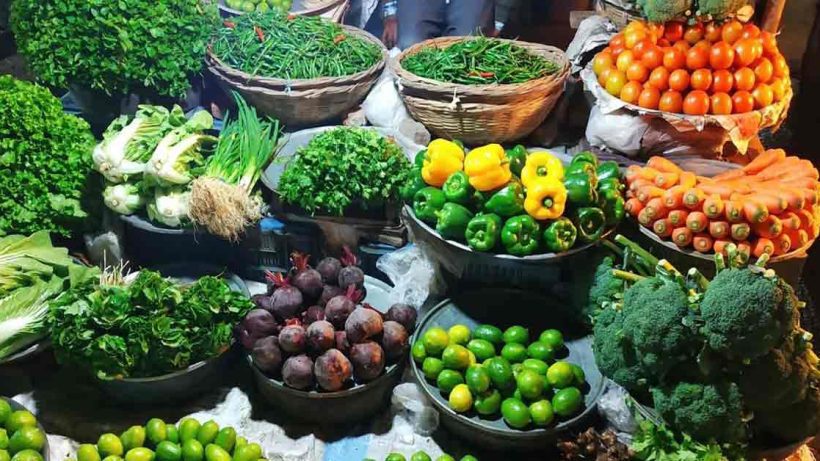 Assorted fresh vegetables including tomatoes, carrots, cucumbers, and bell peppers