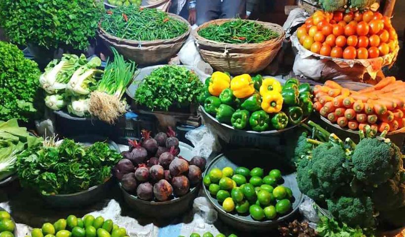 Assorted fresh vegetables including tomatoes, carrots, cucumbers, and bell peppers